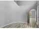 Bright foyer featuring a white wall and wood-look tile, next to a staircase with a unique landing at 470 Regal Downs Cir, Winter Garden, FL 34787