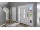 Bright foyer featuring a white front door with decorative glass and sidelights, next to a staircase at 470 Regal Downs Cir, Winter Garden, FL 34787