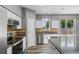 Bright kitchen boasts stainless appliances, granite counters, and views of the pool at 470 Regal Downs Cir, Winter Garden, FL 34787