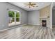 Cozy living room features a fireplace, large windows, and natural lighting at 470 Regal Downs Cir, Winter Garden, FL 34787