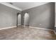 Open living room showcasing tiled flooring and archways that enhance the home's architectural charm at 470 Regal Downs Cir, Winter Garden, FL 34787