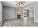 Cozy living room featuring a fireplace and open access to other rooms at 470 Regal Downs Cir, Winter Garden, FL 34787