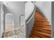 Elegant staircase with wooden steps and modern railings, complemented by stylish flooring and arched doorways at 470 Regal Downs Cir, Winter Garden, FL 34787