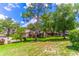 View of a large green backyard, mature trees, and a condominium complex at 489 Meadowood Blvd, Fern Park, FL 32730