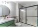 Bathroom features decorative wallpaper, new vanity, and shower/tub with black frame at 489 Meadowood Blvd, Fern Park, FL 32730