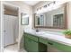 Bathroom with updated cabinets, beautiful countertops, and a large framed mirror at 489 Meadowood Blvd, Fern Park, FL 32730