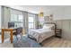This bedroom features neutral walls, wood-look flooring, and a window with natural light at 489 Meadowood Blvd, Fern Park, FL 32730