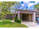 Charming exterior view featuring a covered carport, lush landscaping, and neutral color palette at 489 Meadowood Blvd, Fern Park, FL 32730