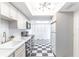 Bright kitchen with checkerboard floor, white cabinets, and stainless steel appliances at 489 Meadowood Blvd, Fern Park, FL 32730