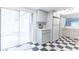 Bright kitchen leading to outdoor patio, featuring white cabinets and checkerboard flooring at 489 Meadowood Blvd, Fern Park, FL 32730