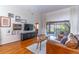 Bright living room with hardwood floors, gallery wall, and sliding glass doors to the patio at 489 Meadowood Blvd, Fern Park, FL 32730