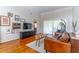 Well-lit living space with hardwood floors, stylish decor, and comfortable seating area at 489 Meadowood Blvd, Fern Park, FL 32730