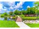 A playground and covered picnic area nestled along the water, connected by a small foot bridge at 489 Meadowood Blvd, Fern Park, FL 32730