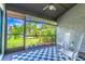 Relax on this cozy screened-in porch with ceiling fan, rocking chairs and a blue and white rug at 489 Meadowood Blvd, Fern Park, FL 32730