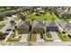Aerial view of well-maintained homes with garages, manicured lawns, and fenced yards in a community at 5217 Creekside Park Ave, Orlando, FL 32811