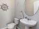Half bathroom with a pedestal sink and decorative ship wheel at 5217 Creekside Park Ave, Orlando, FL 32811