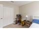 Serene bedroom with a single bed, rocking chair and soft natural light, creating a relaxing atmosphere at 5217 Creekside Park Ave, Orlando, FL 32811
