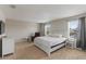 Spacious bedroom with plush carpeting, two windows, and a ceiling fan at 5217 Creekside Park Ave, Orlando, FL 32811