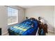 Cozy bedroom featuring a full-size bed, a window for natural light, and a nightstand at 5217 Creekside Park Ave, Orlando, FL 32811