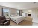 Large bedroom with neutral tones, carpeting, and a view to the bathroom at 5217 Creekside Park Ave, Orlando, FL 32811