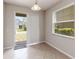 Dining area filled with natural light from a window and sliding glass door at 5217 Creekside Park Ave, Orlando, FL 32811