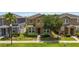 Inviting two-story home with stone accents, manicured bushes, and lush green lawn at 5217 Creekside Park Ave, Orlando, FL 32811