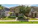 Inviting two-story home with stone accents, manicured bushes, and lush green lawn at 5217 Creekside Park Ave, Orlando, FL 32811