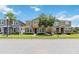 Street view of a two story home with stone accents, attractive landscaping, and a well-maintained lawn at 5217 Creekside Park Ave, Orlando, FL 32811
