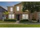 Charming two-story home featuring a stone facade, manicured landscaping, and a welcoming front entrance at 5217 Creekside Park Ave, Orlando, FL 32811