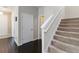 Hallway featuring wood floors, access to stairs, and white trim at 5217 Creekside Park Ave, Orlando, FL 32811