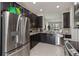 Charming kitchen features dark cabinets, granite countertops, and stainless steel appliances at 5217 Creekside Park Ave, Orlando, FL 32811