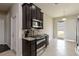 Modern kitchen features stainless steel appliances, dark cabinetry, and granite countertops at 5217 Creekside Park Ave, Orlando, FL 32811