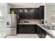 Well-equipped kitchen featuring dark cabinets, stainless steel appliances, and granite countertops at 5217 Creekside Park Ave, Orlando, FL 32811