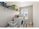 Well-equipped laundry room with a washer, dryer, shelving and a window for natural light at 5217 Creekside Park Ave, Orlando, FL 32811