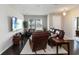Bright living room showcasing a comfortable leather sofa, side table and dark wood flooring at 5217 Creekside Park Ave, Orlando, FL 32811