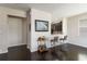 Open-concept living area features dark wood floors and seamless access to the modern kitchen at 5217 Creekside Park Ave, Orlando, FL 32811