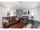 Inviting living room features a comfortable leather sofa and seamless access to the kitchen area at 5217 Creekside Park Ave, Orlando, FL 32811
