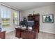 Home office with large windows, wooden desk, comfortable carpeting and ample storage at 5217 Creekside Park Ave, Orlando, FL 32811
