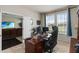 Functional home office features a large desk, comfortable carpeting, and adjacent living room access at 5217 Creekside Park Ave, Orlando, FL 32811