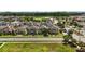 An aerial shot shows an attractive residential area with well-kept homes and green surroundings at 5217 Creekside Park Ave, Orlando, FL 32811
