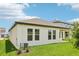 A view of a spacious backyard and covered patio, showing a grassy area and the exterior of the home at 5308 Citrus Leaf Blvd, Winter Garden, FL 34787