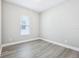 Bright bedroom with wood-look floors and a large window at 5308 Citrus Leaf Blvd, Winter Garden, FL 34787