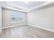 Bedroom showcasing wood-look flooring and natural light from the double windows at 5308 Citrus Leaf Blvd, Winter Garden, FL 34787