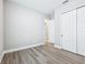 Neutral bedroom with wood-look flooring, closet, and adjoining room at 5308 Citrus Leaf Blvd, Winter Garden, FL 34787
