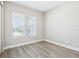Bright bedroom with two large windows that offer natural light and stylish blinds, plus wood floors at 5308 Citrus Leaf Blvd, Winter Garden, FL 34787