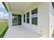 Covered patio featuring a sliding glass door, windows, and access to outdoor water outlets at 5308 Citrus Leaf Blvd, Winter Garden, FL 34787