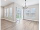 Dining room featuring wood floors, contemporary lighting and large windows overlooking the backyard at 5308 Citrus Leaf Blvd, Winter Garden, FL 34787