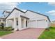 Beautiful single-Gathering home showcasing modern architecture, a two-car garage and a brick driveway at 5308 Citrus Leaf Blvd, Winter Garden, FL 34787