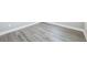 Close-up of modern gray wood-look flooring with white trim at 5308 Citrus Leaf Blvd, Winter Garden, FL 34787