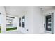 View of the front porch featuring a modern door, windows, and a glimpse of neighborhood at 5308 Citrus Leaf Blvd, Winter Garden, FL 34787
